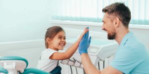 Male Dentist Gives Little Girl High Five - Wall Street Dental Spa NYC