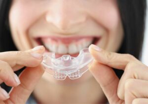 Women Holding a mouth guard